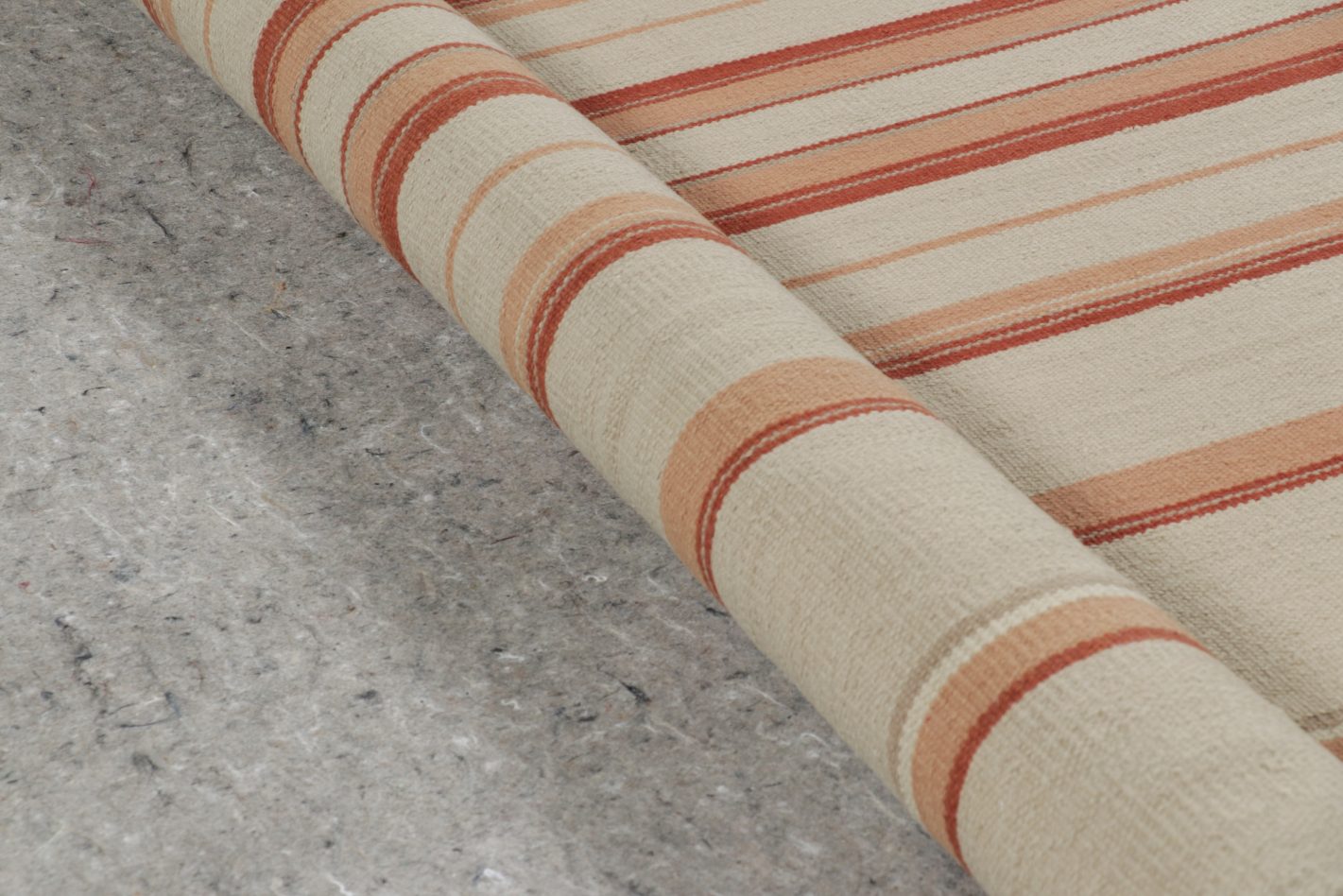 Padding below rolled rug