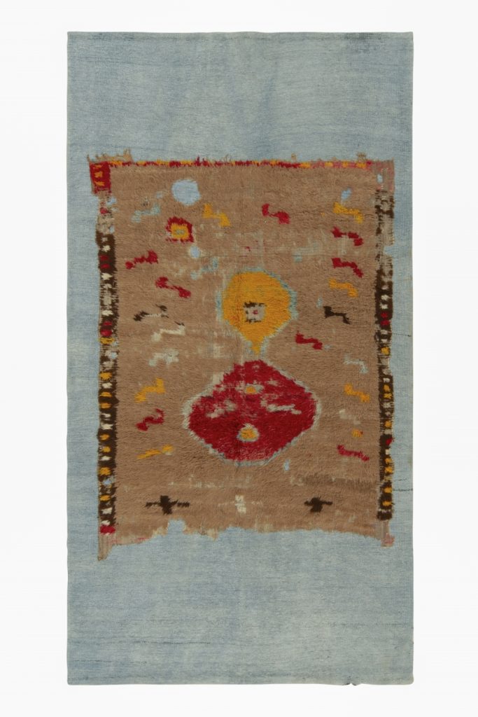 Distressed Brown rug fragment on blue flat weave by Rug & Kilim