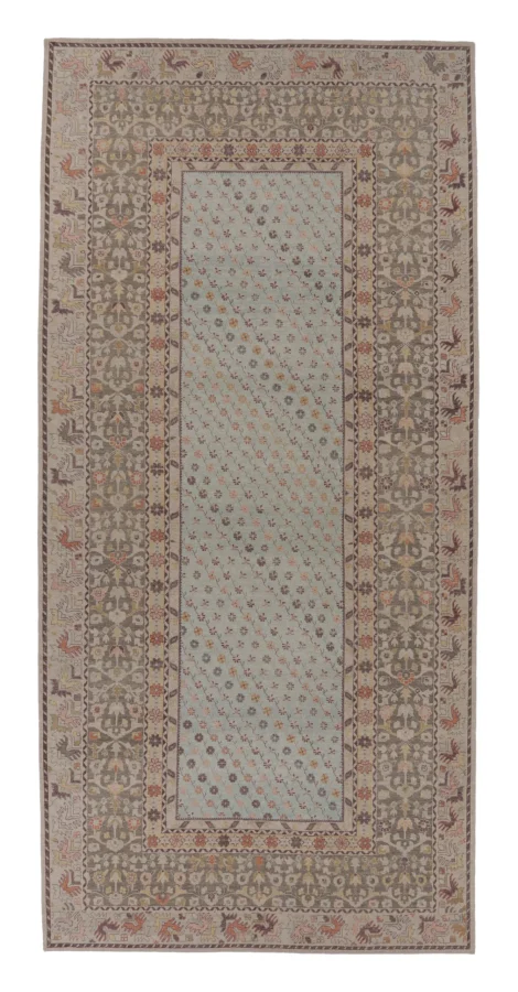 Rug & Kilim’s Distressed Custom Oversized Rug in Light Blue with Floral Patterns